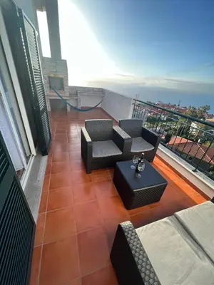 a balcony with couches and a table on a floor at Atlantic Dream Alto Mar in Garajau