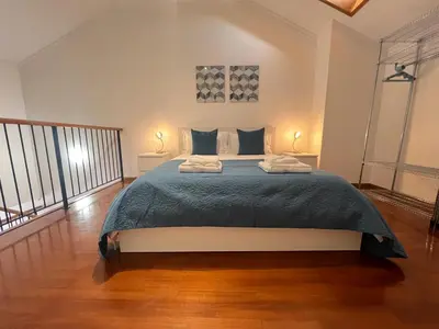 a bedroom with a large bed and two lamps at Atlantic Dream Alto Mar in Garajau