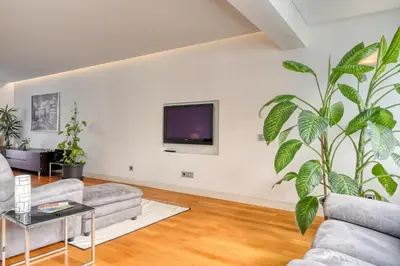 a living room with a large plant on the wall at Jasmineiro, a Home in Madeira in Funchal