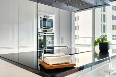 a glass counter in a kitchen with a plant at Jasmineiro, a Home in Madeira in Funchal