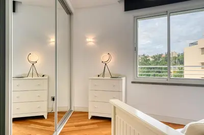 a bedroom with two dressers and a window at Jasmineiro, a Home in Madeira in Funchal
