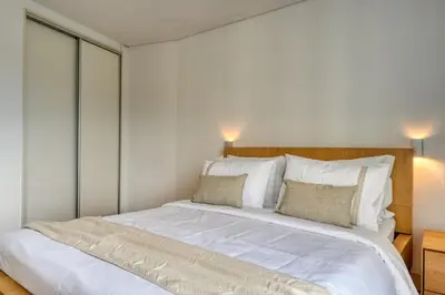 a bedroom with a large white bed with two pillows at Jasmineiro, a Home in Madeira in Funchal