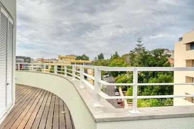 a balcony with a white railing on a building at Jasmineiro, a Home in Madeira in Funchal