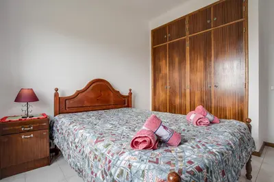 a bedroom with a bed with pink pillows on it at Villa Bartoni in Aljezur