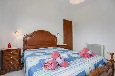 a bedroom with a bed with pink pillows on it at Villa Bartoni in Aljezur