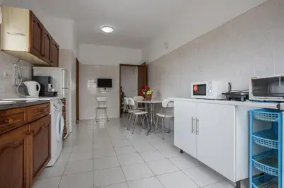 a kitchen with a table and chairs in a room at Villa Bartoni in Aljezur