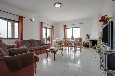 a living room with a couch and a table at Villa Bartoni in Aljezur