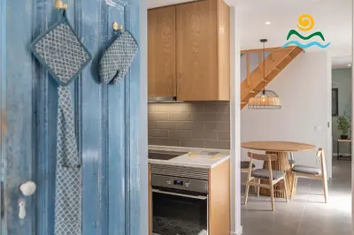 a kitchen with a table and a dining room at Calheta beautiful character cottage Villa Loreto in Arco da Calheta