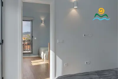 a bedroom with a door leading to a balcony at Calheta beautiful character cottage Villa Loreto in Arco da Calheta