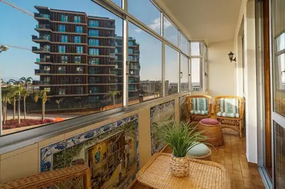 a balcony with a view of a tall building at GuestReady - Varanda de belas lembranças in Funchal