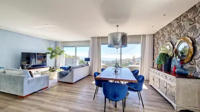 a living room with a table and blue chairs at 24, The Townhouse by LovelyStay in Funchal