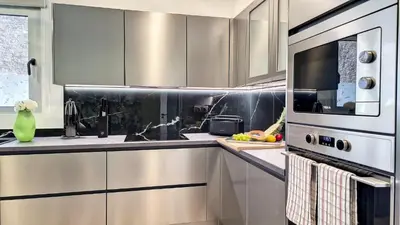 a kitchen with stainless steel cabinets and a microwave at 24, The Townhouse by LovelyStay in Funchal