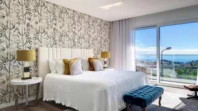 a bedroom with a bed and a large window at 24, The Townhouse by LovelyStay in Funchal