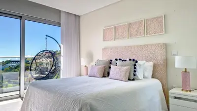 a bedroom with a white bed with a large window at 24, The Townhouse by LovelyStay in Funchal