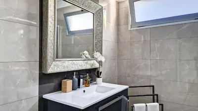 a bathroom with a sink and a mirror at 24, The Townhouse by LovelyStay in Funchal