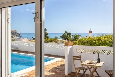 a view of the pool from the balcony of a villa at Casa Coruja in Luz