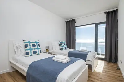 two beds in a bedroom with a large window at Casa Jose Antonio A by Homie in Gaula