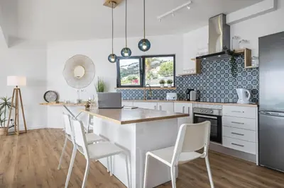 a kitchen with white cabinets and a table and chairs at Casa Jose Antonio A by Homie in Gaula
