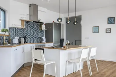 a kitchen with a white counter and white chairs at Casa Jose Antonio A by Homie in Gaula