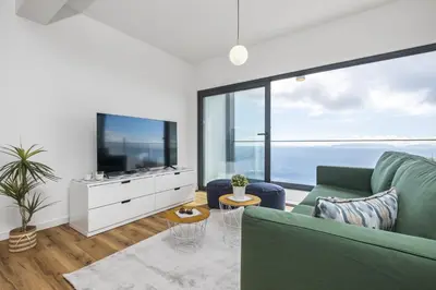 a living room with a green couch and a large window at Casa Jose Antonio A by Homie in Gaula