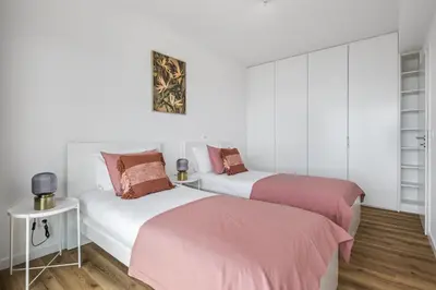 two beds in a room with white and pink at Casa Jose Antonio B by Homie in Gaula