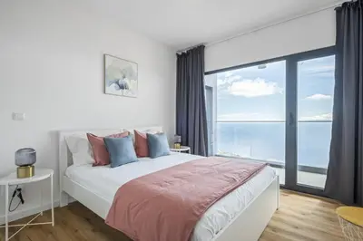 a bedroom with a bed with a view of the ocean at Casa Jose Antonio B by Homie in Gaula