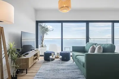 a living room with a blue couch and large windows at Casa Jose Antonio B by Homie in Gaula