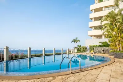 a swimming pool with the ocean in the background at SUPER Cliff in Funchal