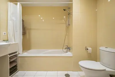 a bathroom with a tub and a toilet and a sink at SUPER Cliff in Funchal