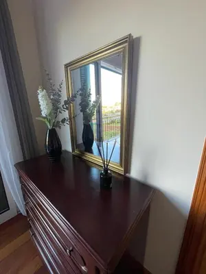 a dresser with two vases and a mirror on it at Wanderlust House in Ponta Delgada
