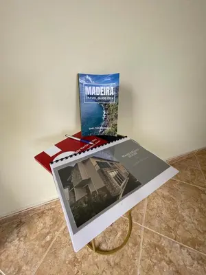 a table with a book and a box on it at Wanderlust House in Ponta Delgada