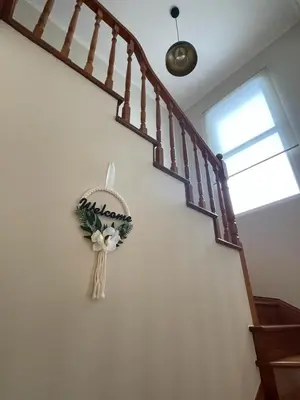 a wreath hanging on a wall next to a staircase at Wanderlust House in Ponta Delgada
