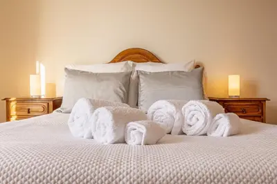 a pile of towels sitting on top of a bed at Villa Angela- Madeira Inn Group in Calheta