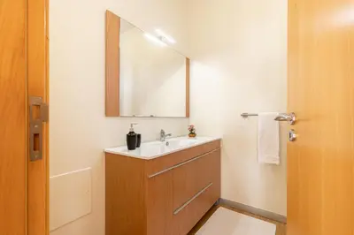 a bathroom with a sink and a mirror at Villa Angela- Madeira Inn Group in Calheta