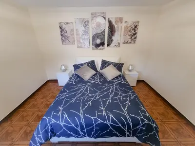 a bedroom with a blue comforter on a bed at Santana Madeira Hiking Getaway near Pico Ruivo and Levadas Base in Santana