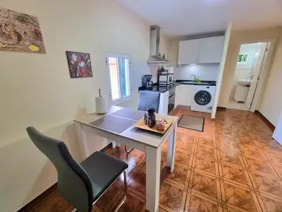 a kitchen with a table and a dining room at Santana Madeira Hiking Getaway near Pico Ruivo and Levadas Base in Santana
