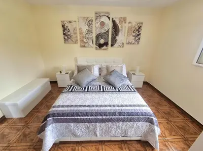 a bedroom with a bed and two pictures on the wall at Santana Madeira Hiking Getaway near Pico Ruivo and Levadas Base in Santana