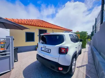 a white suv parked in front of a house at Santana Madeira Hiking Getaway near Pico Ruivo and Levadas Base in Santana