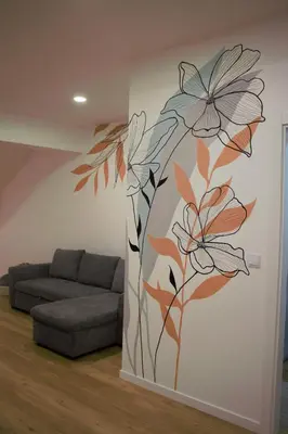 a living room with a mural of flowers on the wall at Mazelia's House in Gaula