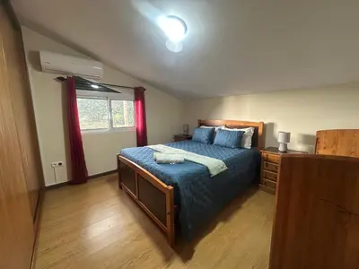 a bedroom with a bed and a sliding glass door at The House of Passos in Ponta do Sol