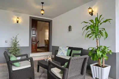 a living room with chairs and a couch at Villa Rosa, a Home in Madeira in Funchal