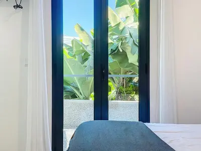 a window with a view of a plant at Madeiran Sweet Home in Funchal