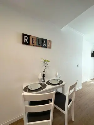 a dining room table with two chairs and a white table at Madeiran Sweet Home in Funchal