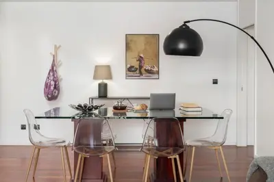 a table with chairs and a laptop in a room at Barreiros IV by An Island Apart in Funchal