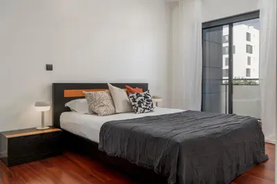 a white bedroom with a large bed with pillows at Barreiros IV by An Island Apart in Funchal