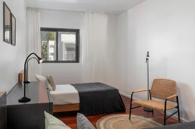 a bedroom with a bed and a desk and a chair at Barreiros IV by An Island Apart in Funchal