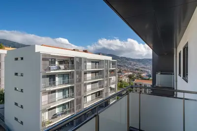 an apartment balcony with a view of a city at Barreiros IV by An Island Apart in Funchal