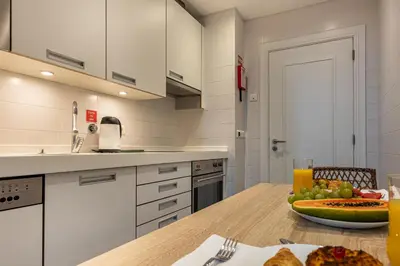 a kitchen with a table with a bowl of fruit on it at Ocean view and Infinity pool Apartment in Funchal