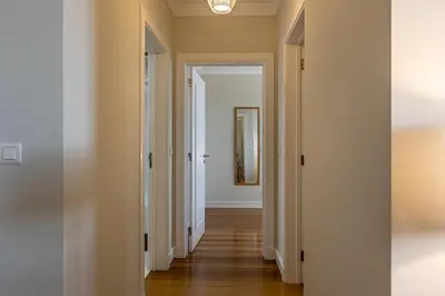 an empty hallway with white walls and wood floors at Ocean view and Infinity pool Apartment in Funchal