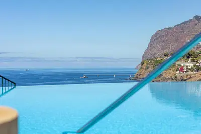 a view of a body of water from a balcony at Ocean view and Infinity pool Apartment in Funchal